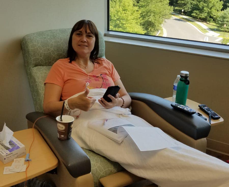 Karla sitting on a chair getting chemo