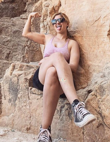 Michelle showing bicep in a hike 