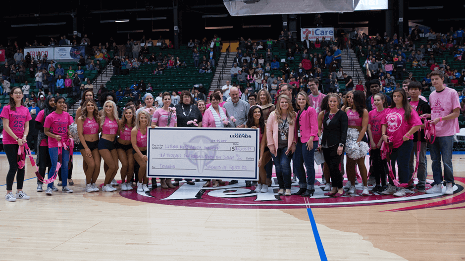 Group takes a photo together to celebrate funds raised for NBCF